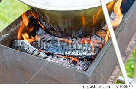 Cauldron boil soup above campfire outdoor camping Cauldron boil soup above campfire outdoor camping 92190679
