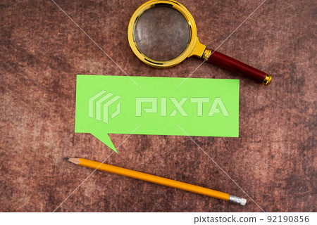 Blank Paper In Thought Bubble Shape With Pencil And Magnifying Glass Placed On Wooden Table. It Is Showing Analyzing And Discovering New Ideas And Strategies For Development. 92190856
