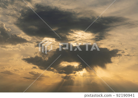 Clouds block the sun at sunset in the form of a human face Clouds block the sun at sunset in the form of a human face 92190941