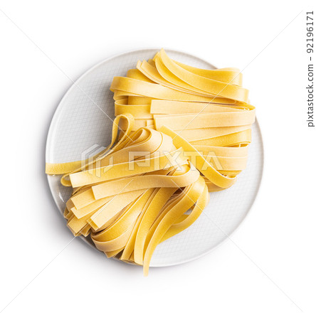 Uncooked pappardelle pasta isolated on white background. 92196171