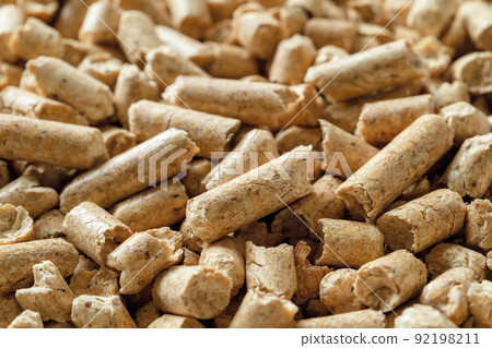 Wooden pellets macro background. Texture of compressed sawdust granules. 92198211