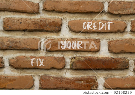 Fix your credit symbol. Concept words Fix your credit on red bricks on a beautiful brick wall background. Business, finacial and fix your credit concept. Copy space. 92198259
