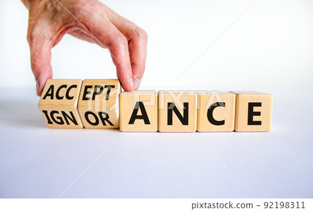 Acceptance or ignorance symbol. Businessman turns cubes, changes the word 'ignorance' to 'acceptance'. Beautiful white table, white background. Business, acceptance or ignorance concept. Copy space. 92198311