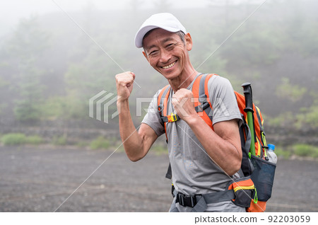 Mountain climbing image fist pump smile 92203059