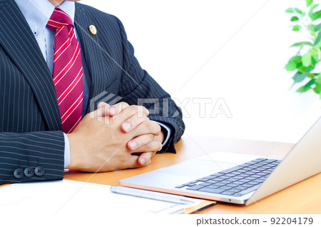 A male lawyer who joins hands and listens to a consultation A male lawyer who joins hands and listens to a consultation 92204179