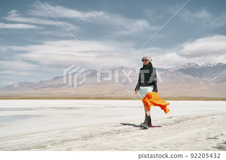 asian woman female tourist in long skirt walking on saline alkali land 92205432