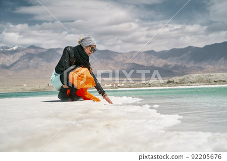 asian woman female tourist touching the water of a salt lake 92205676