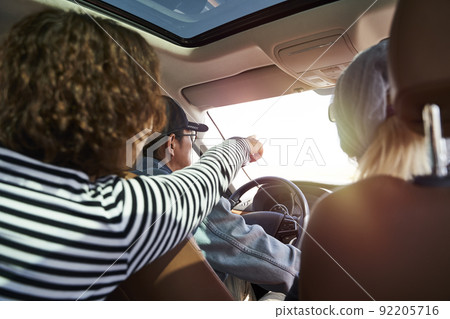 group of asian friends enjoying a sightseeing trip by car 92205716