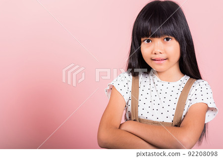 Asian little kid 10 years old smiling with arms crossed 92208098