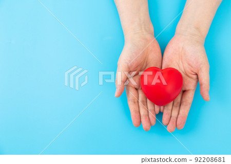 Middle woman's hand with a heart 92208681