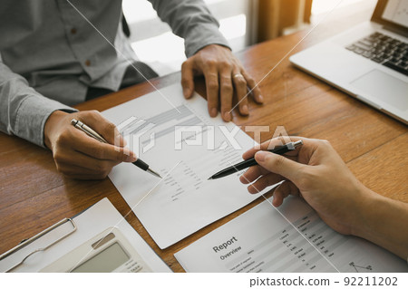 Colleagues are stress talking about the finance results report and compared with the financial information on the paperwork with analysis about planning in the future. Colleagues are stress talking about the finance results report and compared with the financial information on the paperwork with analysis about planning in the future. 92211202