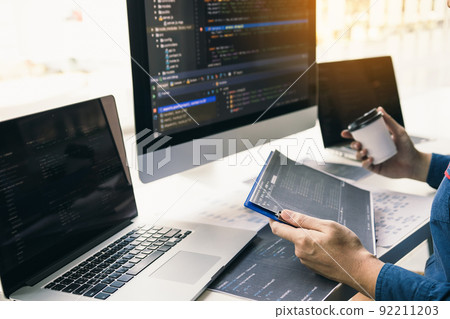 Asian man working code program developer computer web development working design software on desk in office. Asian man working code program developer computer web development working design software on desk in office. 92211203