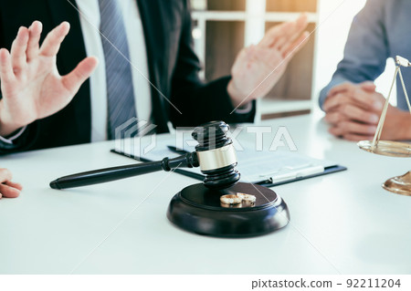 Lawyer is telling him to calm down as the sweetheart clients are going to file for divorce at the prosecutor office. Lawyer is telling him to calm down as the sweetheart clients are going to file for divorce at the prosecutor office. 92211204