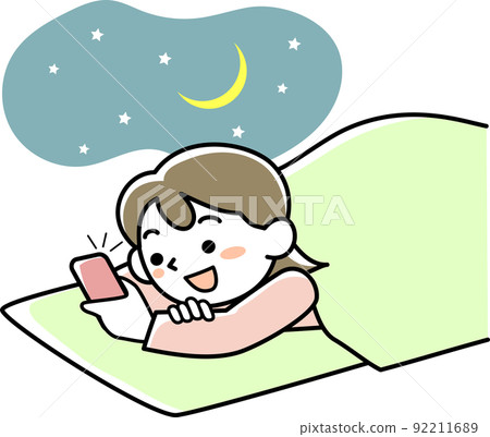 Young woman looking at smartphone while sleeping 92211689