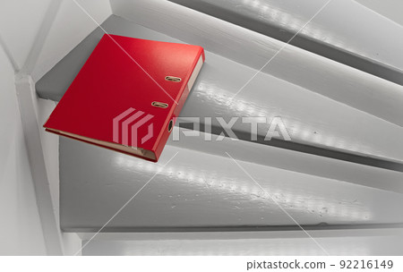 Red file on the stairs, selective focus Red file on the stairs, selective focus 92216149