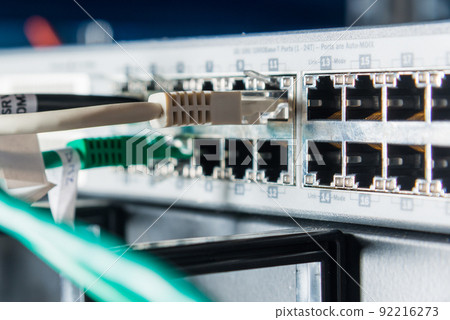 Detail of server with patch cables plugged in ethernet ports Detail of server with patch cables plugged in ethernet ports 92216273