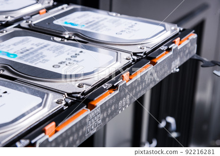 close up of hard disk drives inside hosting center - server rack filled with trays full of data storage drives 92216281