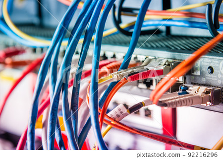 Detail of server with patch cables plugged in ethernet ports Detail of server with patch cables plugged in ethernet ports 92216296