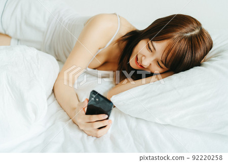 Young woman relaxing and lying down Young woman relaxing and lying down 92220258