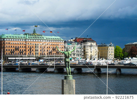 Stockholm/Sweden - May 16 2011:.View of historic buildings at Stockholm waterfront and Sun Singer Statue at Stromparterren Park near Norrbro (North Bridge) and the Royal Castle in the Old Town 92221675