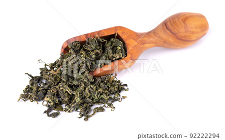 Dry gynostemma pentaphyllum leaf in olive scoop, isolated on white blackground. Jiaogulan or Miracle grass. Chinese herbal tea. Dry gynostemma pentaphyllum leaf in olive scoop, isolated on white blackground. Jiaogulan or Miracle grass. Chinese herbal tea. 92222294
