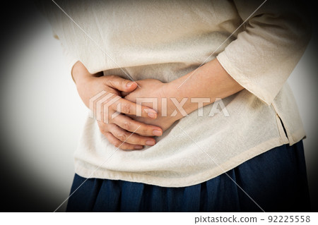 Middle female suffering from abdominal pain Middle female suffering from abdominal pain 92225558