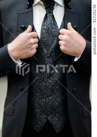 Elegance male hands wearing modern black suit Elegance male hands wearing modern black suit 92226236