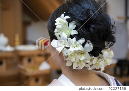 From behind the bride's hair set preparing for the wedding From behind the bride's hair set preparing for the wedding 92227166