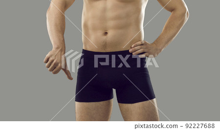 Young man who is having problems with getting an erection is showing a thumbs down Young man who is having problems with getting an erection is showing a thumbs down 92227688