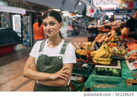 Woman seller of fruit at the market near the counter 92228624