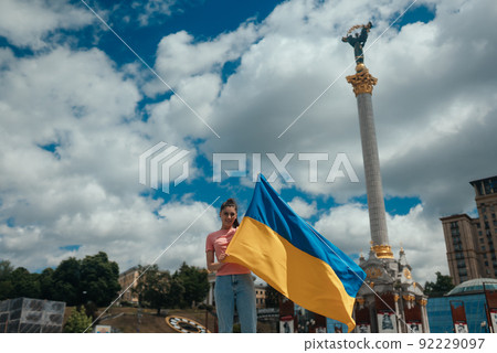 Young woman with national flag of Ukraine on the street Young woman with national flag of Ukraine on the street 92229097