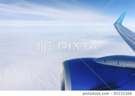 Airplane flight background. View from the airplane window to the sky and clouds. 92233166