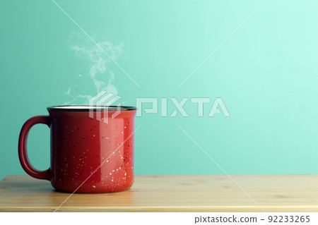 Cup minimal concept. Cup with hot coffee or tea on a blank colored background. 92233265