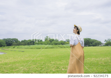 Young woman in the back walking in the park Young woman in the back walking in the park 92234173