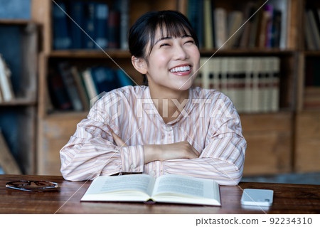 Young woman reading in a chic room Young woman reading in a chic room 92234310