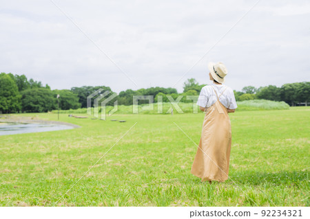 Young woman in the back walking in the park 92234321