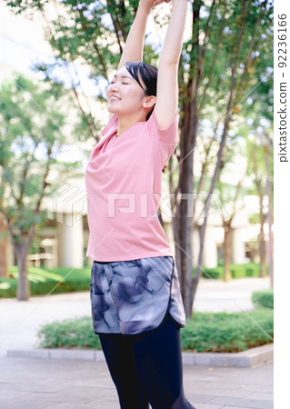 Women in sportswear doing stretching Women in sportswear doing stretching 92236166