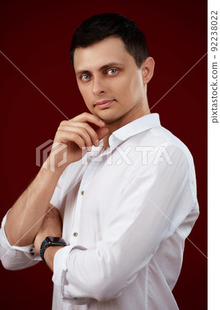 man holding arms folded, touching chin with hand man holding arms folded, touching chin with hand 92238022