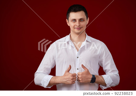 brunette man in t-shirt smiling and showing ok sign 92238023