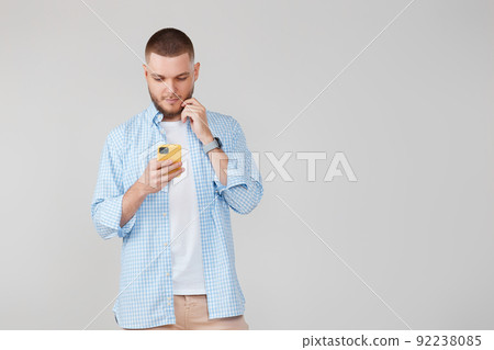 handsome man with mobile cell phone surfing internet handsome man with mobile cell phone surfing internet 92238085