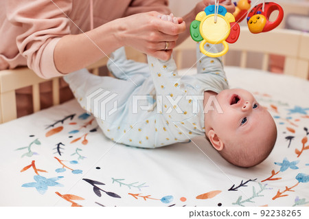 Baby massage. Mother doing gymnastics with newborn child 92238265