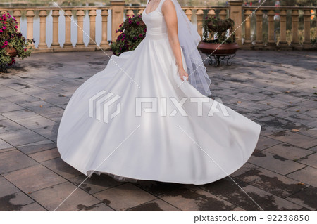 the bride on the embankment in a wedding dress 92238850