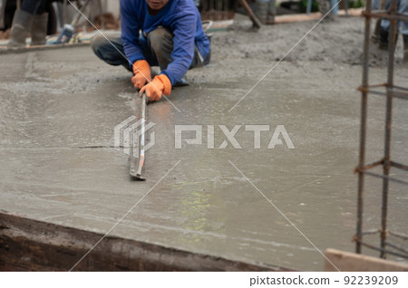 worker is adjusting the concrete 92239209