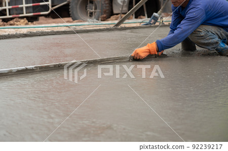 worker is adjusting the concrete 92239217