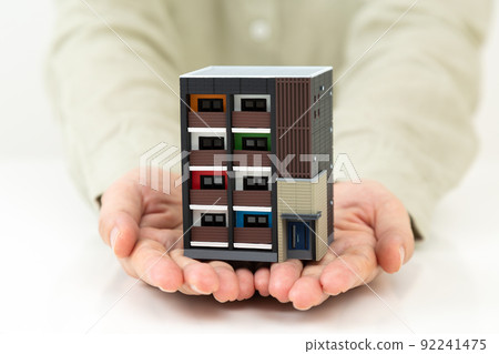 Middle woman with a house model 92241475