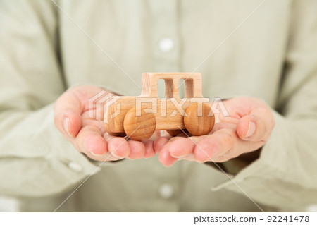 Middle woman holding a car model 92241478