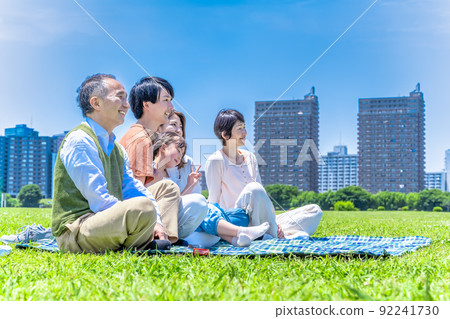 Three generations of good friends relaxing in the park Three generations of good friends relaxing in the park 92241730
