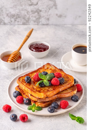 French toast with blueberries, raspberries, maple syrup French toast with blueberries, raspberries, maple syrup 92242849