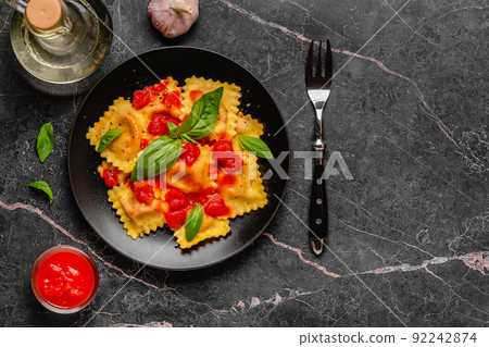 Delicious appetizing ravioli with tomato sauce and basil 92242874
