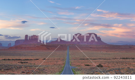 Scenic Road in the Dry Desert with Red Rocky Mountains in Background. Scenic Road in the Dry Desert with Red Rocky Mountains in Background. 92243811